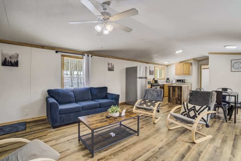 A spacious and comfortable living area with plenty of seating, perfect for gathering with family and friends. The open layout seamlessly connects to the kitchen and dining area for a welcoming atmosphere.