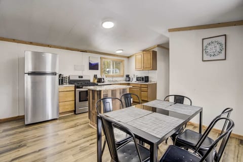 The open-concept kitchen and dining area create a welcoming space for shared meals and conversation. Equipped with modern appliances and plenty of counter space for easy meal prep.