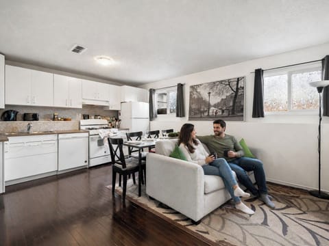 Open-concept living room and kitchen with modern appliances and comfortable seating