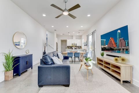 A bright and airy living space with modern furnishings, natural light, and an open flow into the kitchen and dining area—perfect for entertaining or relaxing after a day in the city.