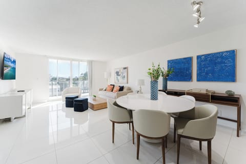 Full view of the living room with balcony access and plenty of light.