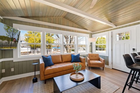 The living room space at the Harbor Cottage is the perfect cozy place to relax and take in the views of Fish Creek Harbor across the street.