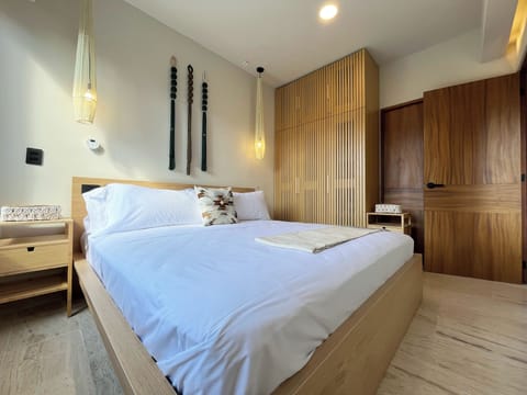 Enjoy a king size bed, premium bedding & macrame decor in a serene penthouse.