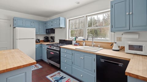 - Spacious kitchen with bright window lighting   - Functional layout with large gas stove and sink   - Perfect for preparing meals before adventures