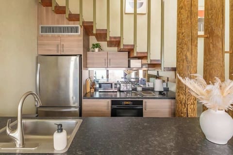 The kitchen comes equipped with high-end large and small appliances