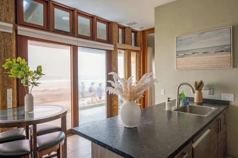 Watch the waves crash against the sand while you cook dinner