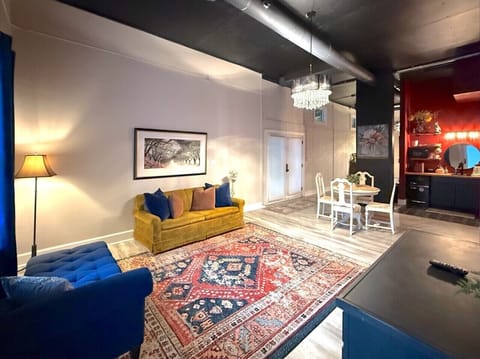 Relax in this stylish open living and dining space, featuring cozy seating, colorful décor, and a bright, welcoming atmosphere.