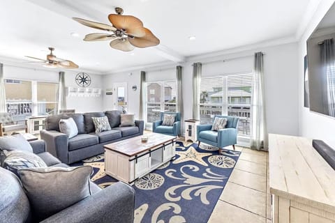 Bright, stylish living room with cozy seating, smart TV, and a cozy vibe