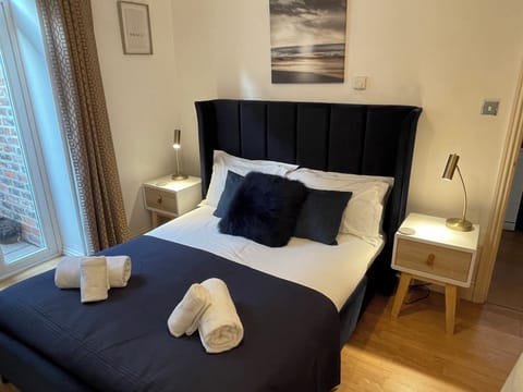 King size bed with bed side tables and reading lamps.