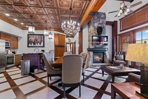 Elegant lodge-style living room with antler chandelier and mountain charm.