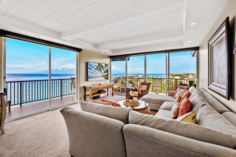 Unwind in a bright and welcoming living area, complete with a flat-screen TV and comfortable furnishings. Perfect for peaceful lounging.
