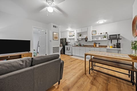 Centrally located in the apartment is an open area with access to the kitchen, dining table, and living room area. 