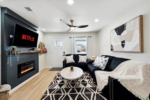 Kick back in this comfy living room with a cozy couch and a big TV, perfect for streaming your favorite shows after a day exploring the Heard Natural Science Museum.