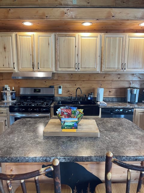 Kitchen, counter top, and bar stool area