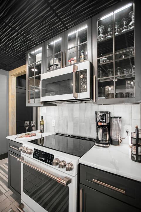 The fully stocked kitchen features a versatile GE Café microwave.