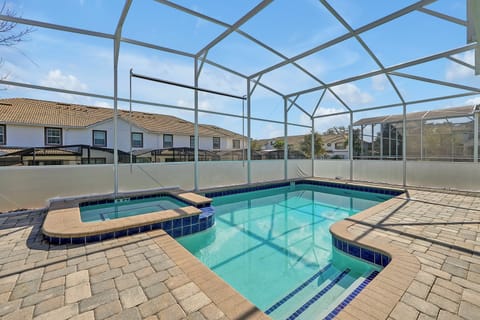 Enjoy your own screened-in pool with a spa and sun loungers, perfect for relaxing after a day at the parks.