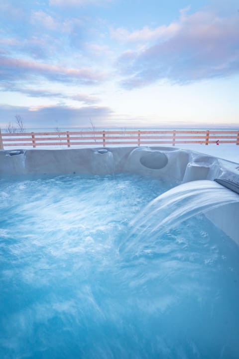Let the warm bubbles melt your cares away under the sky.