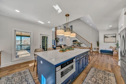 Open concept living space, perfect for entertaining. Door to outside leads upper patio.