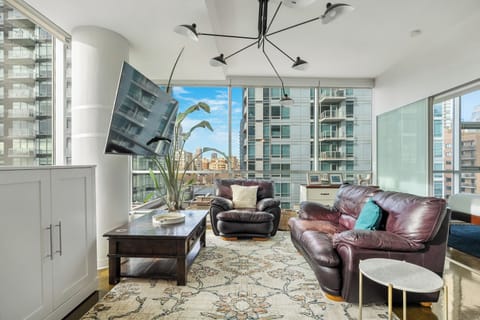 Bright living space with floor-to-ceiling windows and city views.