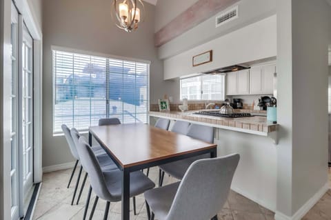 Dining table sitting up against the kitchen bar