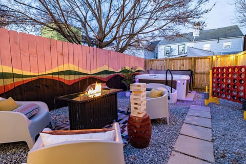 Unwind in this private oasis featuring a cozy fire pit, hot tub, oversized games, and vibrant mural art. Perfect for late-night laughs and laid-back vibes! 🌙✨