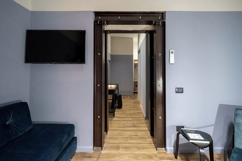Deluxe Triple Room, Balcony | In-room safe, desk, laptop workspace, blackout drapes