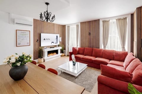 Living Room | The beautiful living room features a 75 inch TV, full air conditioning, and a large sofa that converts into a sofa bed, creating a bright space ideal for relaxing, unwinding after a day in the city, or enjoying quality time with family 