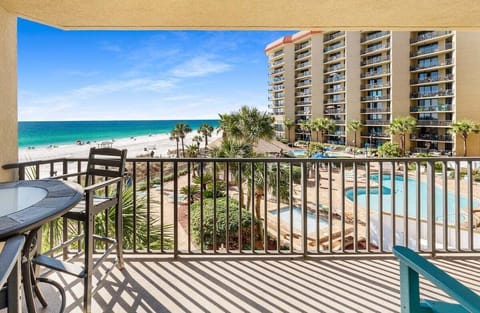 This expansive balcony stretches seamlessly across both the living room and primary bedroom, offering breathtaking ocean views and stunning sunset vistas.