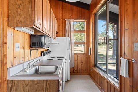 Kitchen with a view! Enjoy cooking meals while taking in the beautiful outdoor scenery through the large window.