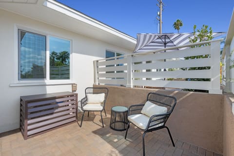 Experience your semi-private patio, featuring two chairs and a small table, ideal for basking in the sun while enjoying your morning coffee.