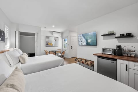 This modern, well equipped kitchenette with a small fridge, microwave, toaster oven/air fryer combo, and Keurig coffee maker -perfect for effortless meals and morning coffee with a dining table that seats 4 guest.