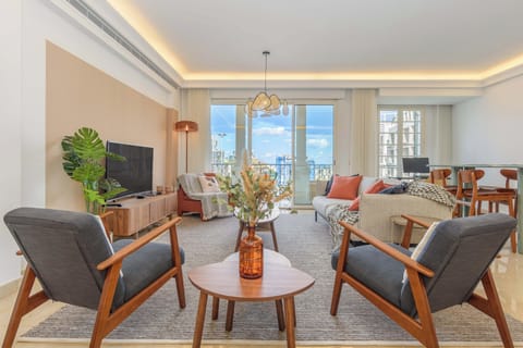 Apartment, 2 Bedrooms, City View, Courtyard Area | Living room | 55-inch Smart TV with cable channels, offices