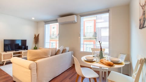 Bright and stylish open-plan living and dining area with natural light and views of charming local architecture. #NaturalLight #CozyLiving #UrbanCharm