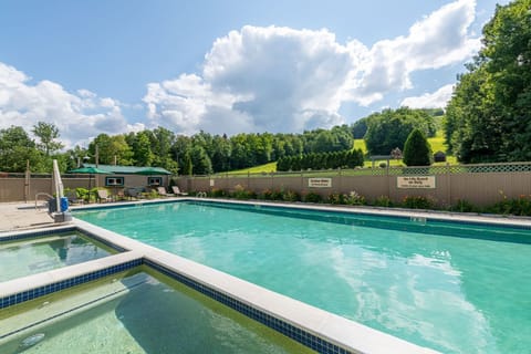 Relax and recharge in a peaceful poolside setting, surrounded by Vermont’s natural beauty.