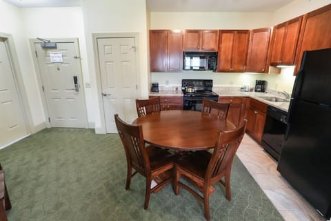 Stylish kitchen with modern appliances and a cozy dining area, perfect for enjoying meals at home.