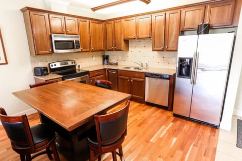 Fully equipped kitchen with modern appliances and a dining area for enjoying home-cooked meals.