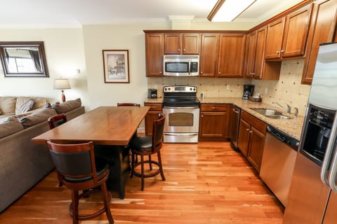 Well-equipped kitchen with wooden cabinetry and stainless steel appliances, perfect for preparing meals.