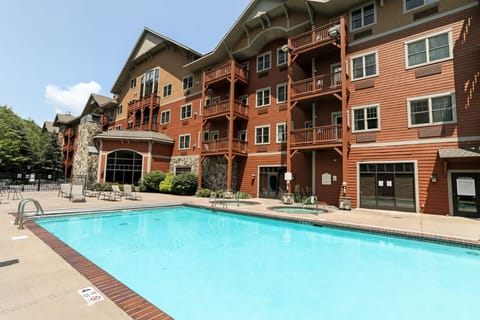 Refreshing outdoor pool surrounded by mountain charm, perfect for a relaxing dip after a day of adventure.