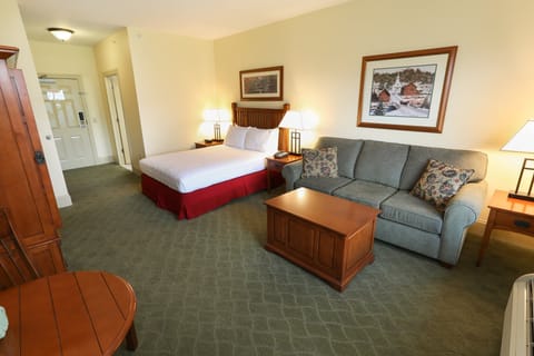 Comfortable room with plush bed and seating area, ideal for relaxation.