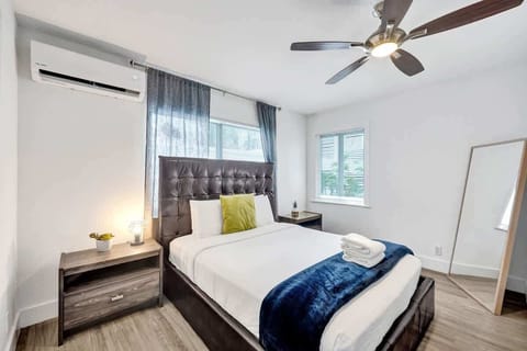 Sunlit bedroom with king bed and mini-split AC