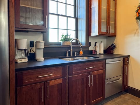 Custom designed kitchen with granite island and island seating to enjoy family cooking with all the extra kitchen amenities at Tamm Loft.