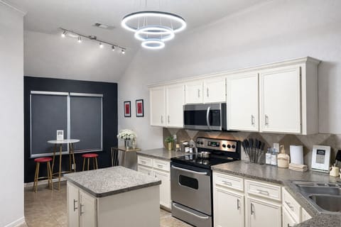 Fully equipped kitchen and bar seating for intimate meals.