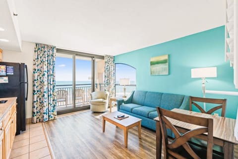 Enjoy rare sunrise & sunset views from this oceanfront living room with panoramic floor-to-ceiling windows. Relax on the private balcony, soak in the coastal-chic décor, and experience the ultimate beachfront escape! Stay at Beach Cove Resort