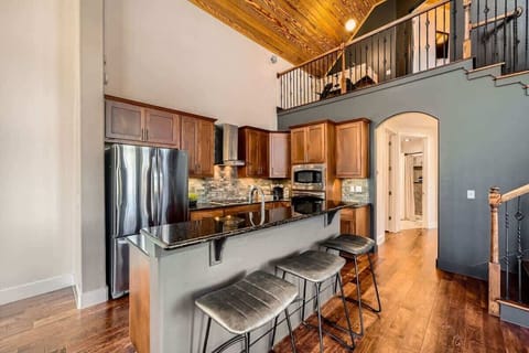 Spacious kitchen with a large island and seating, ideal for enjoying morning coffee or group meal prep.