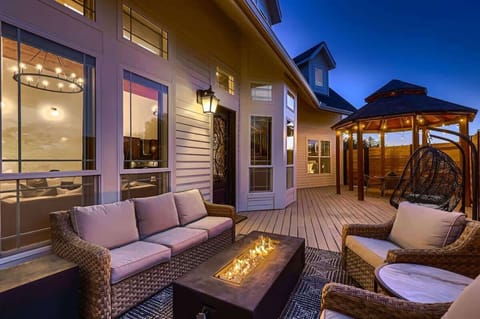 Relaxing patio with a mix of comfortable lounge chairs and soft lighting for an intimate setting.