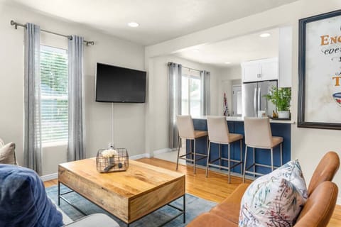 Open concept living room connected to kitchen & dining