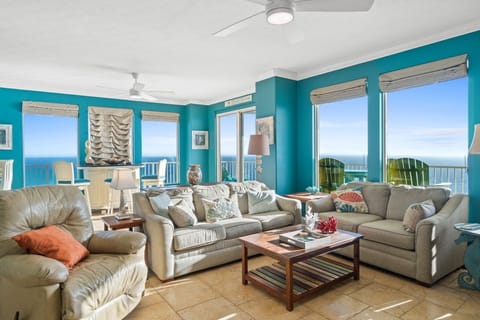 Relax in this bright living room with ocean views and comfortable seating.