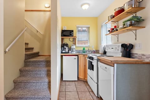 Start your morning with a fresh cup of coffee in this well-stocked kitchenette.