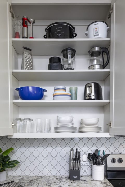 Your home-away-from-home kitchen comes with stainless steel appliances — stove, microwave, refrigerator, dishwasher, coffee maker, and toaster — fully stocked with plates, cutleries, and everything you need for a seamless stay.