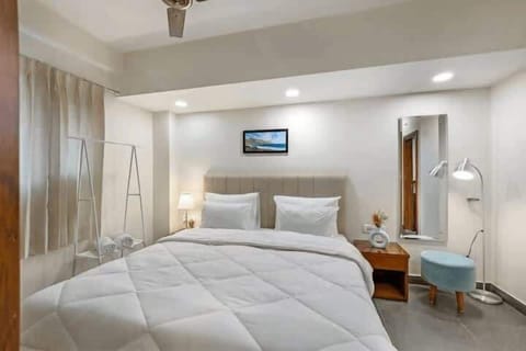 A cozy bedroom scene with a cup of tea on a bedside table, offering a warm and comforting atmosphere.